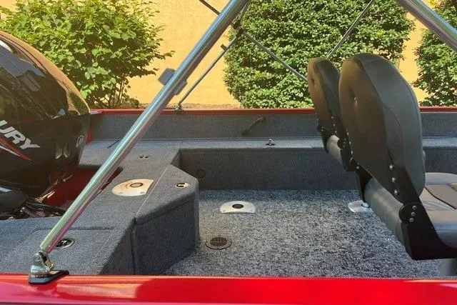 Slide: The Image of 2026 Tracker Pro Guide V-16 SC boat interior with seating and Mercury engine. - 7