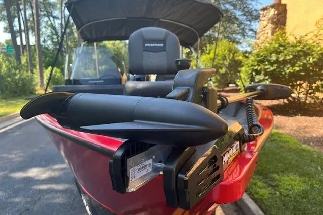 Slide: The Image of 2026 Tracker Pro Guide V-16 SC boat with Minn Kota trolling motor, parked outdoors. - 2