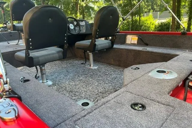 Slide: The Image of Interior of 2026 Tracker Pro Guide V-16 SC boat with seating and controls. - 8