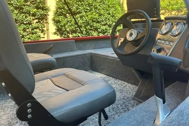 Slide: The Image of 2026 Tracker Pro Guide V-16 SC boat interior with steering wheel and seats. - 5