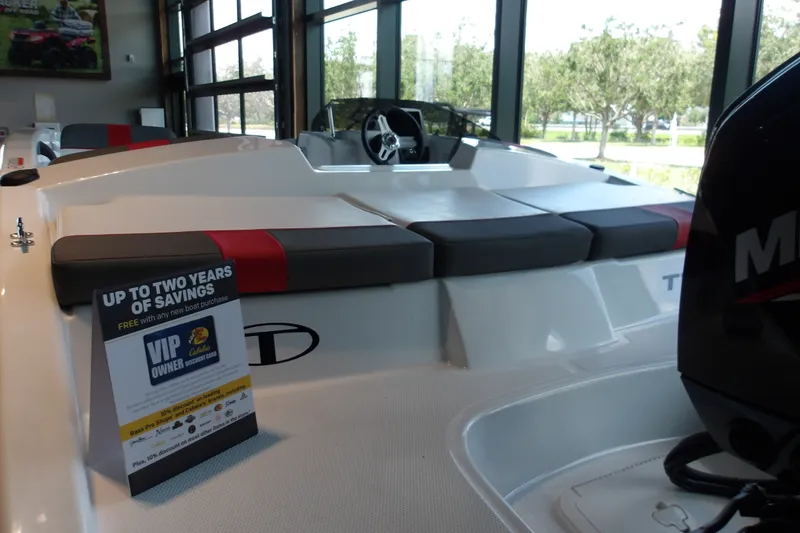 Slide: The Image of 2026 Tahoe T16 boat interior with promotional savings sign, showcasing sleek seating and modern design. - 14