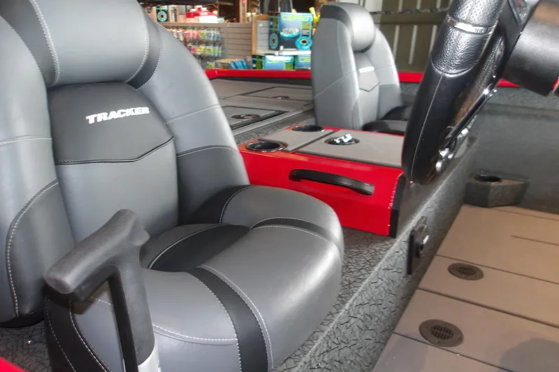 Slide: The Image of Interior of 2026 Tracker Savage 215 boat with sleek seating and modern controls. - 17