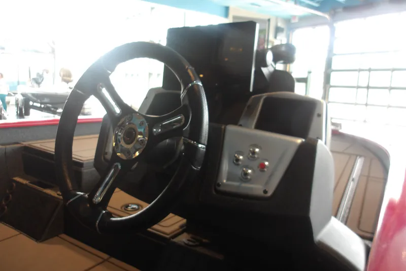 Slide: The Image of Steering wheel and dashboard of 2026 Tracker Savage 215 boat in showroom. - 16