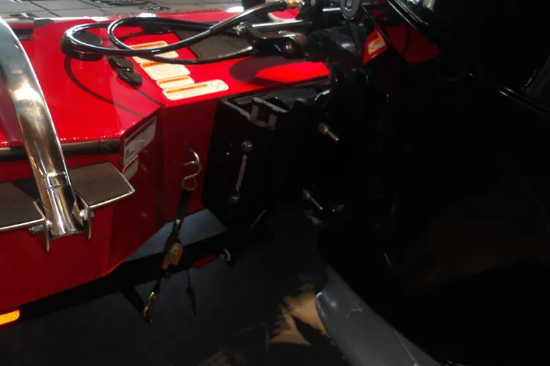 Slide: The Image of Rear view of 2026 Tracker Savage 215 boat with red and black detailing. - 7