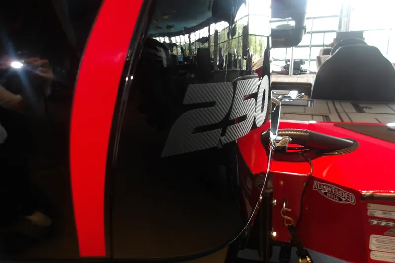 Slide: The Image of 2026 Tracker Savage 215 boat with bold red and black design, featuring "250" decal. - 4