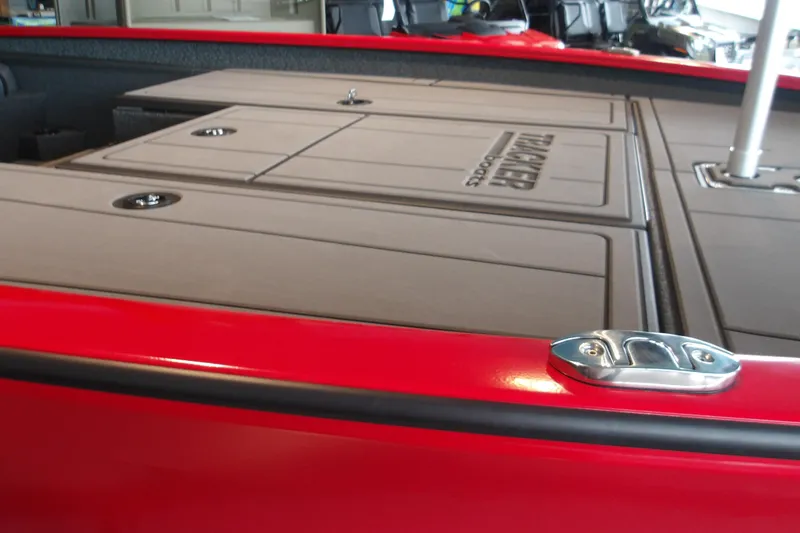 Slide: The Image of Red 2026 Tracker Savage 215 boat deck with storage compartments and sleek design. - 15