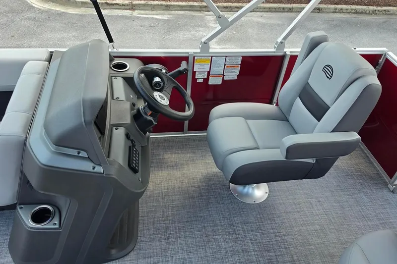 Slide: The Image of Interior of 2026 Sun Tracker Party Barge 18 DLX with steering console and captain's chair. - 12