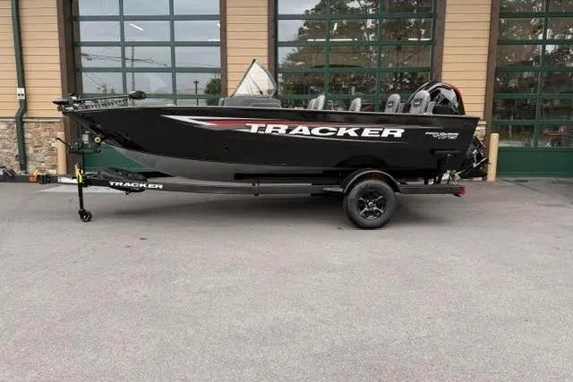 The Image of 2026 Tracker Pro Guide V-175 Combo boat on trailer, parked outdoors. - 0