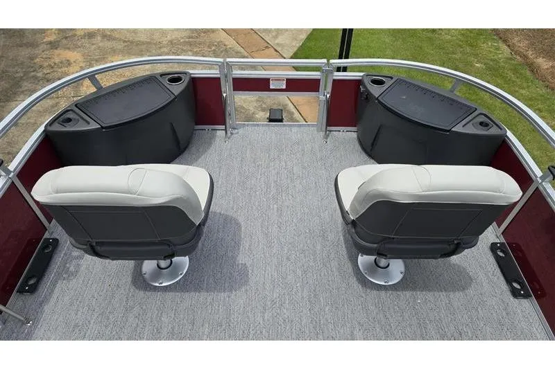 Slide: The Image of 2026 Sun Tracker Bass Buggy 18 DLX pontoon boat interior with swivel seats and storage compartments. - 8