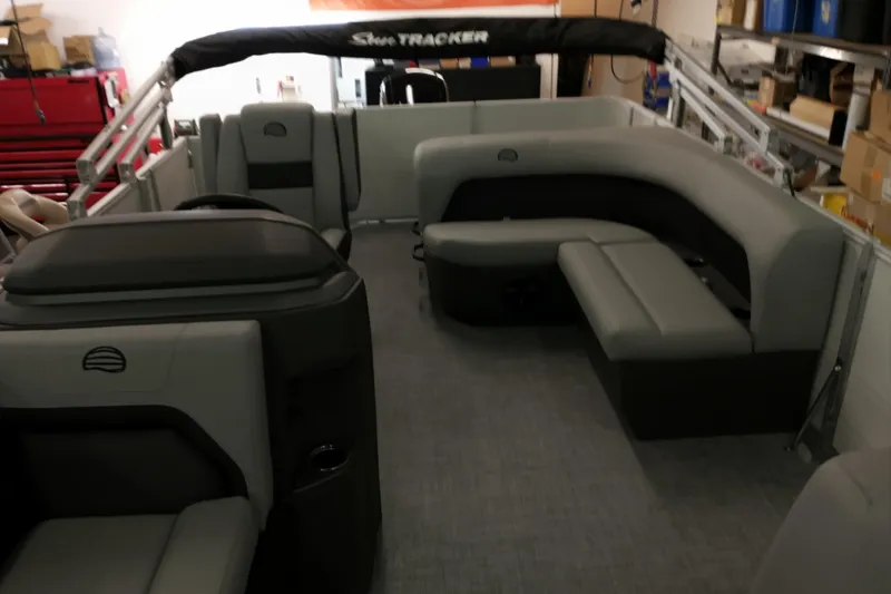 Slide: The Image of 2026 Sun Tracker Party Barge 18 DLX interior with gray seating and spacious layout. - 4
