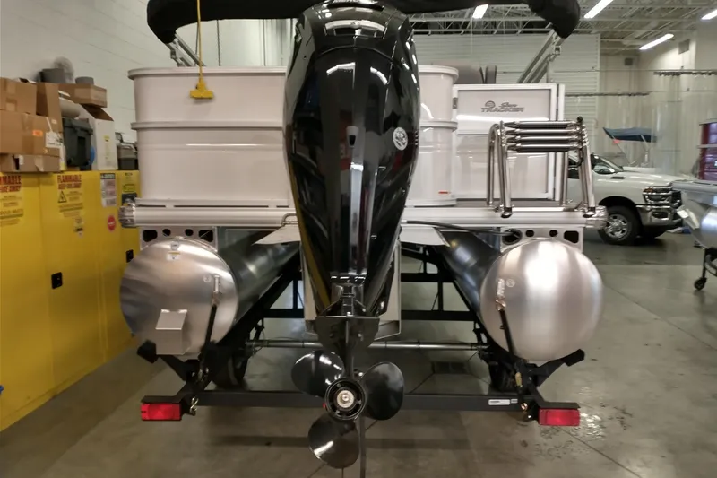 Slide: The Image of 2026 Sun Tracker Party Barge 18 DLX pontoon boat in a showroom, rear view. - 5