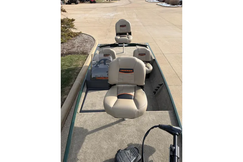 Slide: The Image of 2026 Tracker Bass Tracker Classic Limited boat with beige seats on a driveway. - 2