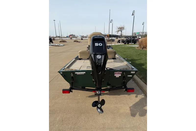 Slide: The Image of 2026 Tracker Bass Tracker Classic Limited boat with 50 HP motor, parked outdoors. - 3