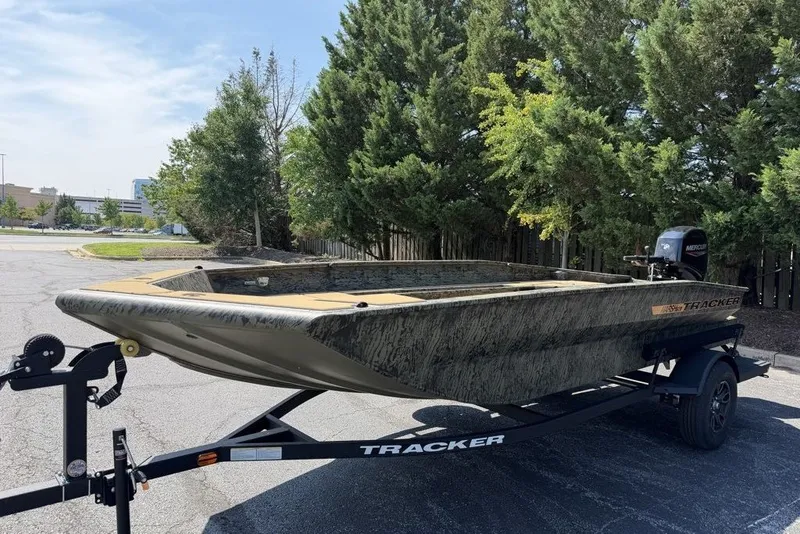The Image of 2026 Tracker Grizzly 2072 CC boat on trailer, parked outdoors near trees. - 0