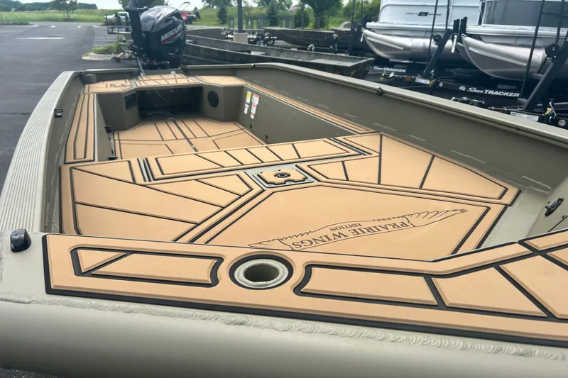 Slide: The Image of 2026 Tracker Grizzly 1650 T Prairie Wings Edition boat interior with custom flooring. - 2