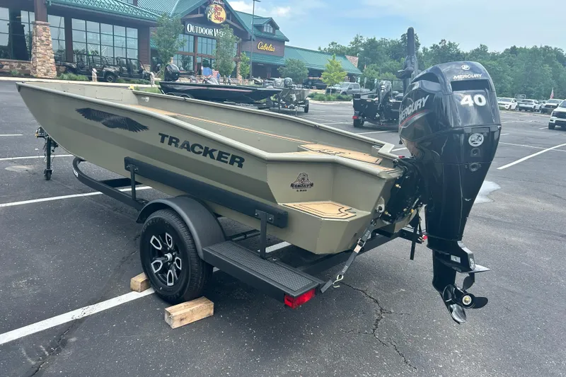 Slide: The Image of 2026 Tracker Grizzly 1650 T Prairie Wings Edition boat with Mercury 40 engine in parking lot. - 10
