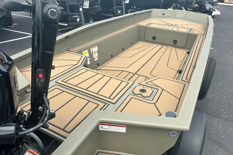 Slide: The Image of 2026 Tracker Grizzly 1650 T Prairie Wings Edition boat interior with tan deck design. - 7
