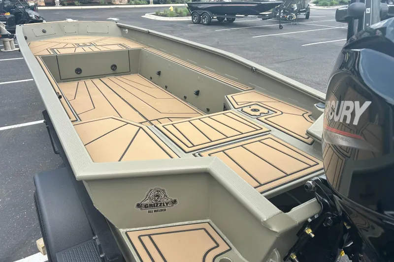 Slide: The Image of 2026 Tracker Grizzly 1650 T Prairie Wings Edition boat with spacious deck and Mercury engine. - 9
