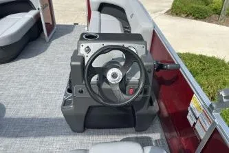 Slide: The Image of 2026 Sun Tracker Party Barge 16 DLX steering console with modern design and comfortable seating. - 4