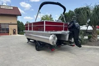Slide: The Image of 2026 Sun Tracker Party Barge 16 DLX pontoon boat parked outdoors on a sunny day. - 2