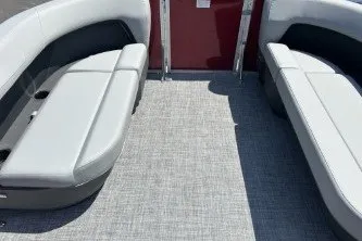 Slide: The Image of 2026 Sun Tracker Party Barge 16 DLX interior with gray seating and carpeted floor. - 71