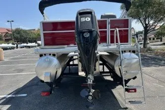 Slide: The Image of 2026 Sun Tracker Party Barge 16 DLX pontoon boat with 50 HP motor in parking lot. - 72