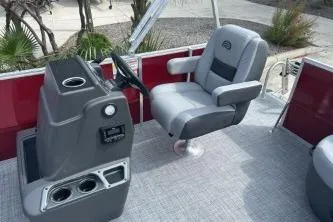 Slide: The Image of 2026 Sun Tracker Party Barge 16 DLX interior with captain's chair and console. - 5