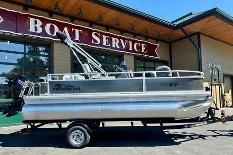 The Image of 2026 Sun Tracker Bass Buggy 18 DLX pontoon boat at a boat service center. - 0
