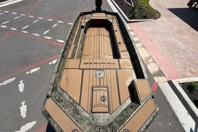 Slide: The Image of 2026 Tracker Grizzly 1756 T Marsh boat on pavement, showcasing sleek design and spacious deck. - 4