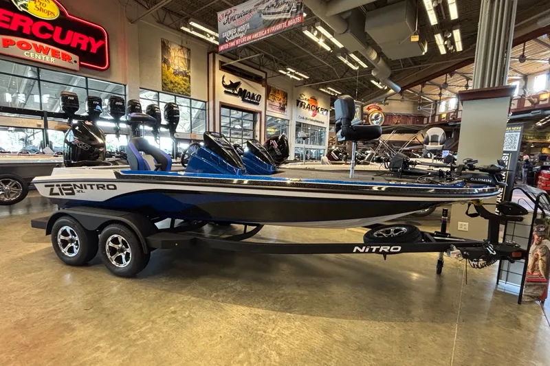 Slide: The Image of 2026 Nitro Z19 XL Pro boat displayed in showroom with dual motors and sleek design. - 1