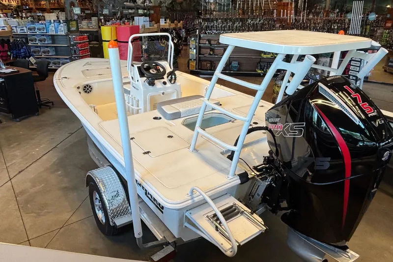 Slide: The Image of 2026 Mako 18 Pro Skiff boat with Mercury Pro XS engine in showroom. - 2