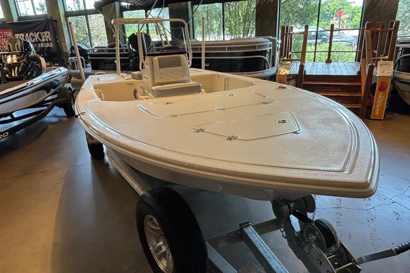 Slide: The Image of 2026 Mako 18 Pro Skiff boat displayed indoors on a trailer. - 4