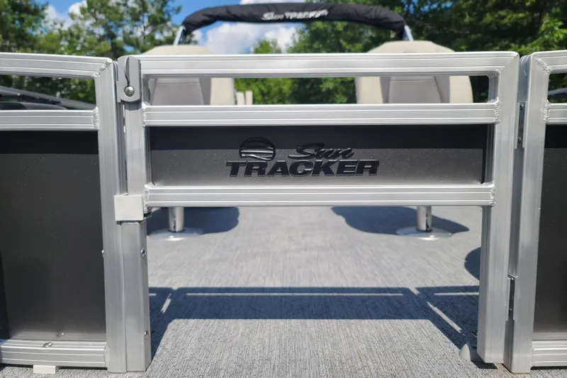 Slide: The Image of 2026 Sun Tracker Bass Buggy 18 DLX pontoon boat entrance with logo. - 13