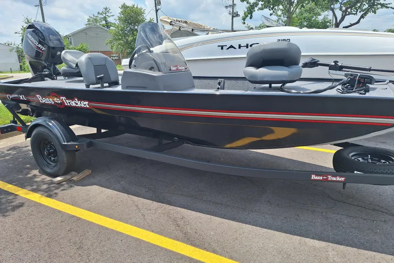 The Image of 2026 Tracker Bass Tracker Classic XL boat parked on a trailer in a lot. - 0