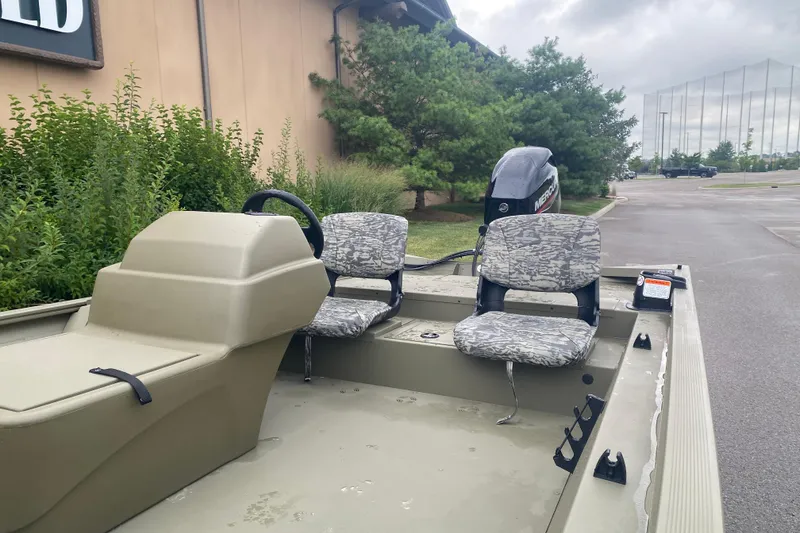 Slide: The Image of 2026 Tracker Grizzly 1754 SC boat with camouflage seats and Mercury outboard motor. - 3