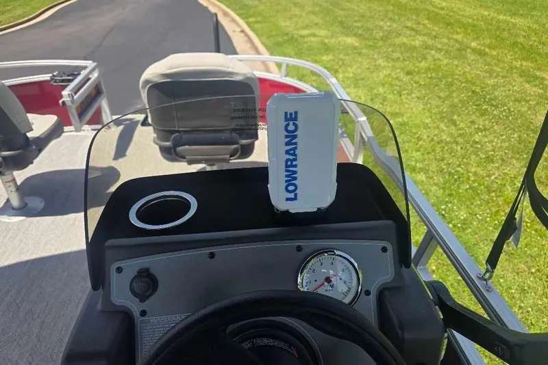 Slide: The Image of 2026 Sun Tracker Bass Buggy 16 XL Select dashboard with Lowrance device and steering wheel. - 5