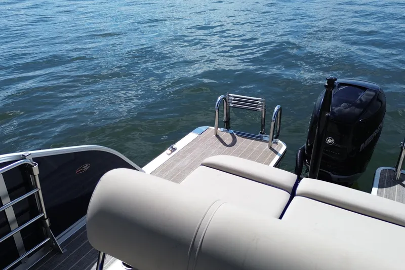 Slide: The Image of 2022 Harris Grand Mariner 250 boat with outboard motor on calm water. - 12
