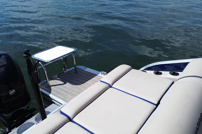 Slide: The Image of 2022 Harris Grand Mariner 250 boat with seating and swim platform on water. - 13