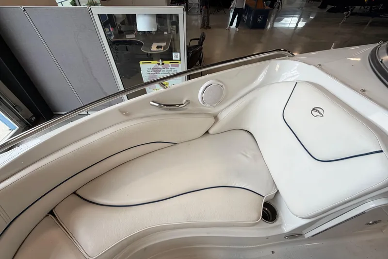 Slide: The Image of 2008 Crownline 220 LS boat interior with white cushioned seating and speaker. - 14