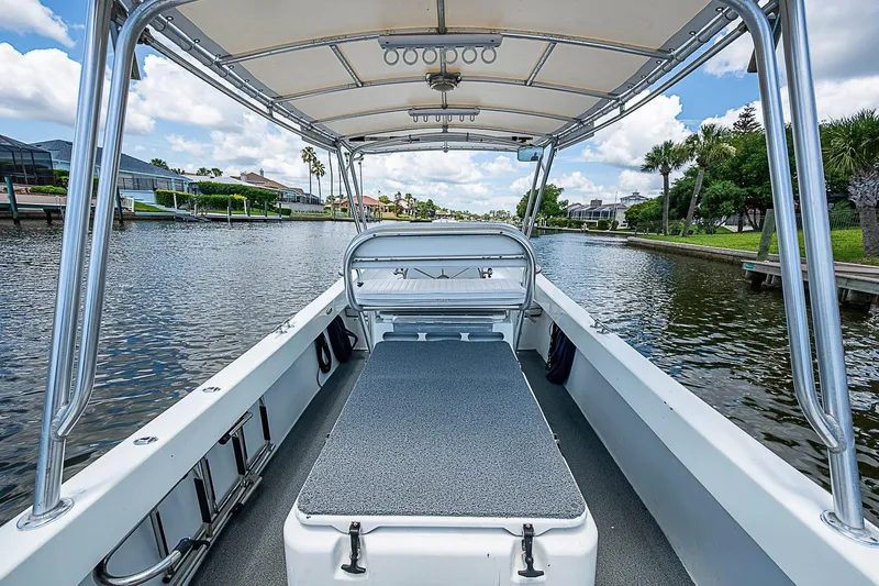 Slide: The Image of Custom 1969 boat interior with canopy, cruising on a scenic waterway under a blue sky. - 16