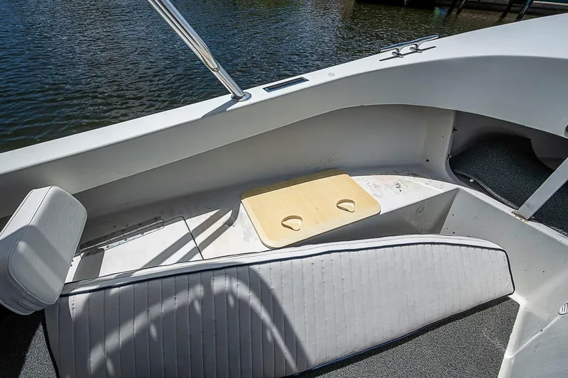 Slide: The Image of Interior of a 1969 custom boat with seating and cup holders by the water. - 20