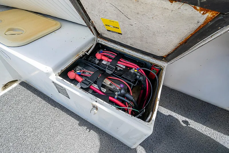 Slide: The Image of Open battery compartment in a 1969 custom vehicle, showing wiring and connections. - 21