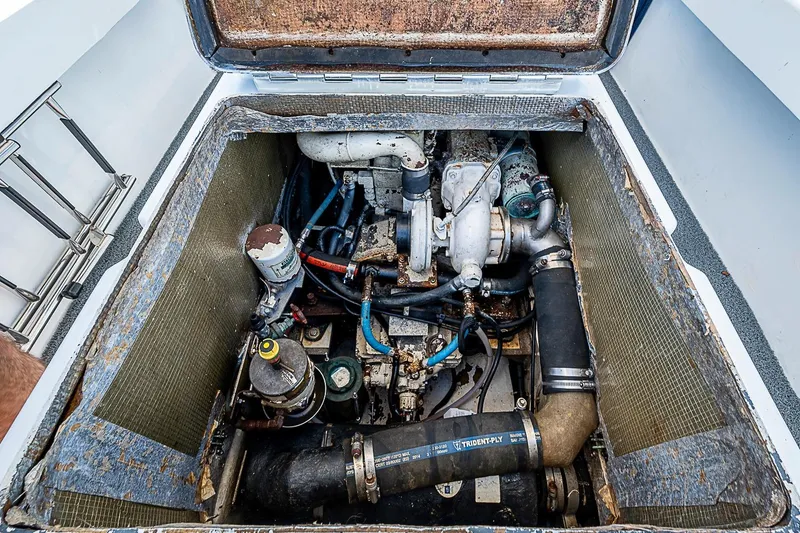 Slide: The Image of 1969 custom engine compartment with visible components and hoses in a boat. - 22