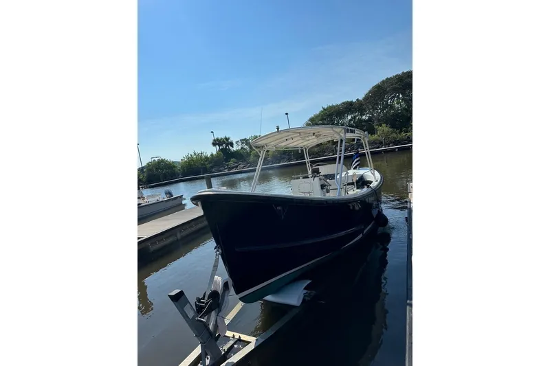 Slide: The Image of 1997 Ocean Technical Services boat docked in a serene marina setting. - 29