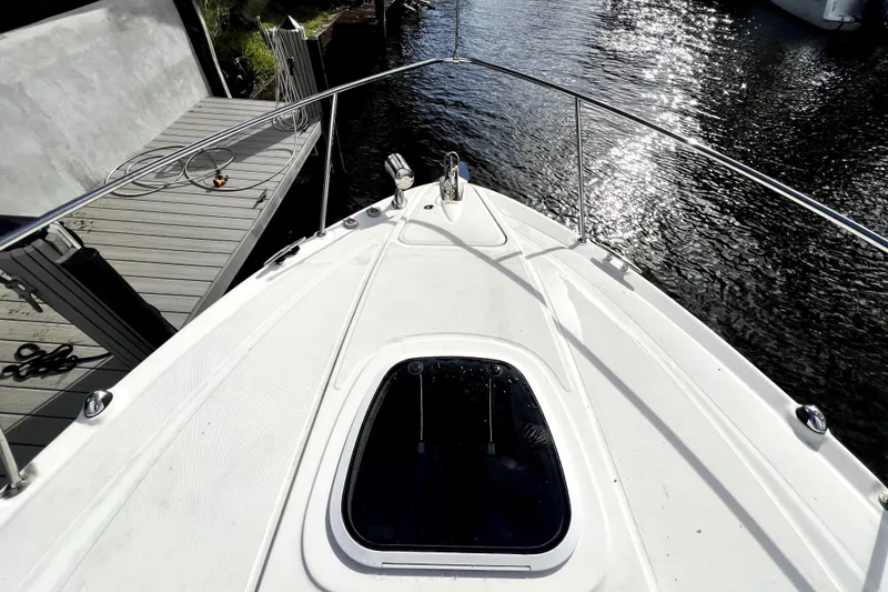 Slide: The Image of Bow view of 2007 Sea Ray Sundancer 310, docked with sunlit water reflections. - 15