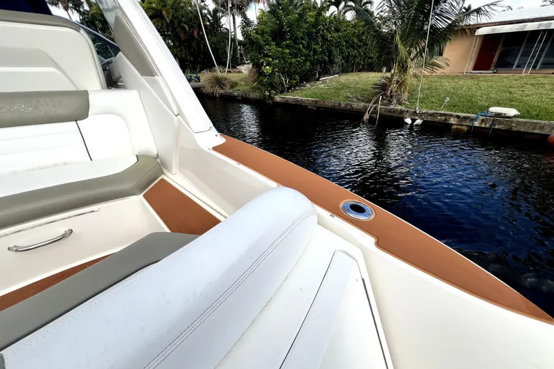 Slide: The Image of 2007 Sea Ray Sundancer 310 boat interior with water view, featuring sleek seating and elegant design. - 16