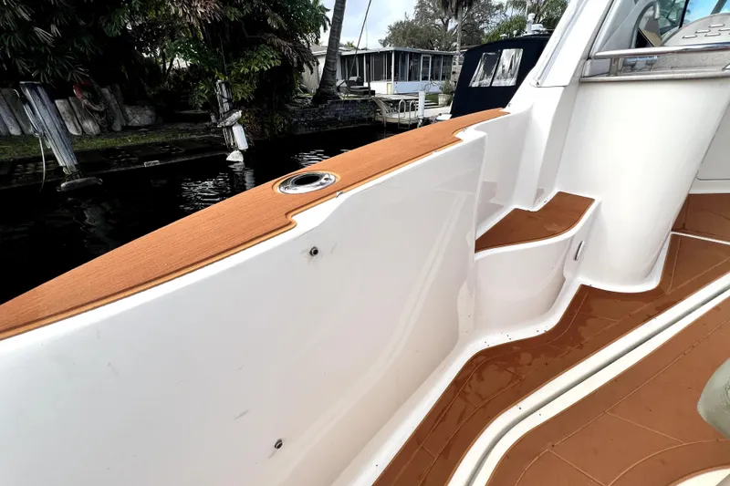 Slide: The Image of 2007 Sea Ray Sundancer 310 boat deck with wood accents and water view. - 17
