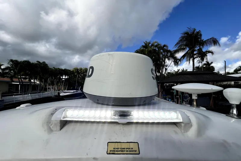Slide: The Image of 2007 Sea Ray Sundancer 310 boat with radar and LED light, under cloudy sky. - 18