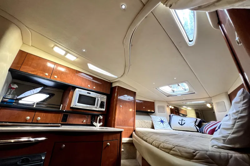 Slide: The Image of Luxurious interior of 2007 Sea Ray Sundancer 310 yacht with cozy cabin and kitchenette. - 30