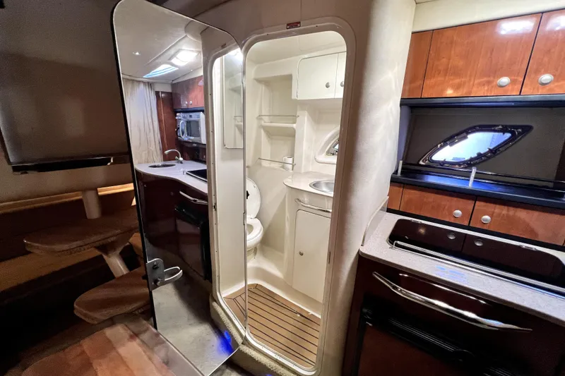 Slide: The Image of 2007 Sea Ray Sundancer 310 interior with kitchenette, bathroom, and seating area. - 33